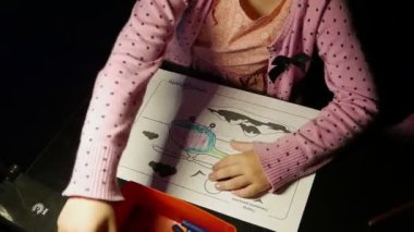 Evde çizim yapan sevimli küçük bir kızın görüntüleri.