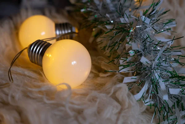 Christmas garland lights on a white carpet — Stock Photo, Image