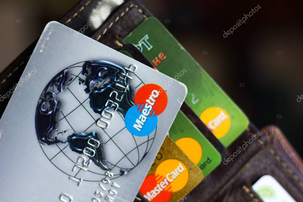 Ryazan, Russia - February 27, 2018: Credit card of Maestro brand over the leather wallet and number of cards