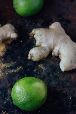 Siyah köy yüzeyinde yeşil kireç ve zencefil.