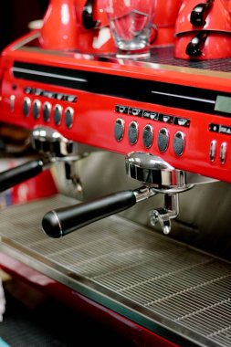 Kafe veya restorandaki kırmızı metal kahve makinesi.