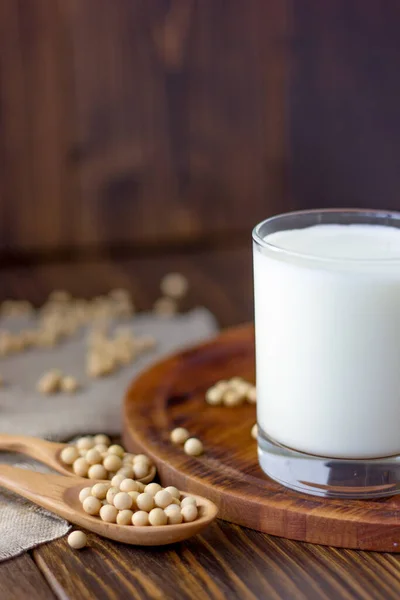 Soy milk with soy beans around it