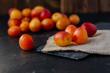 Taze ve olgun yaban eriği veya siyah yüzeyde kiraz eriği