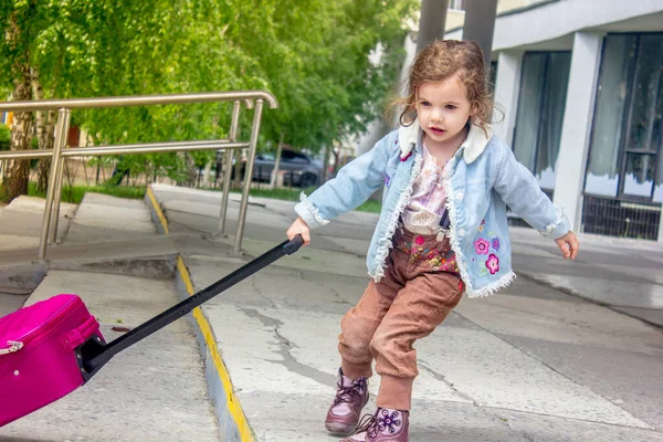 Little girl travel alone. Now she on the railway station