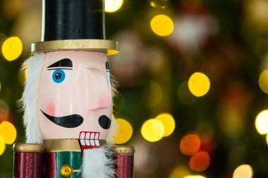 Arka planda bokeh efektli Noel ağacı olan fındıkkıran