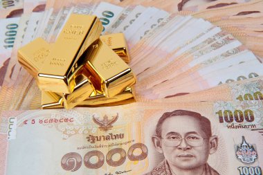 5 of 1 kg. Gold bar on the 1000 Baht of Thailand banknotes nested a pile high clipart