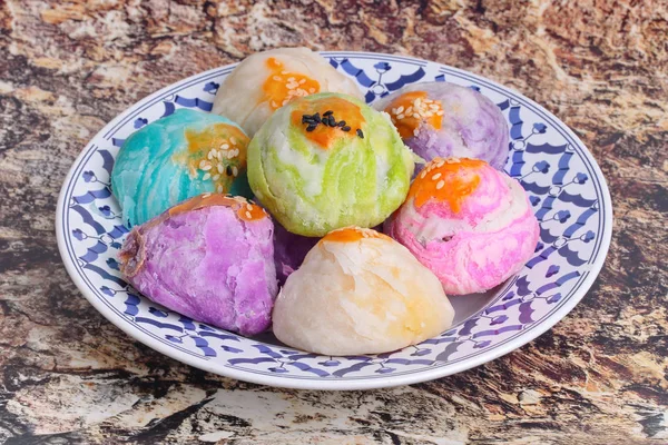 Colorful Chinese pastry moon cake ,Spring Roll pastry with nuts, salted eggs ,on Thai style plate .