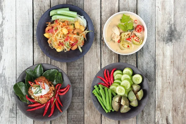 Isolated of Chinese vegetable festival as spicy papaya salad with mixed vegetable,Coconut milk and fermented soy bean sauce,Streamed vegetable curry in banana leaf cup with mixed vegetables