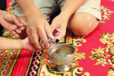 Budistler hak, boşalırcasına su şişe bardağa, sonra iyi bir iş yapmak ve Budizm için servet paylaşmak. İyi başkalarına paylaşmak anlamına gelir. Seçici odak.