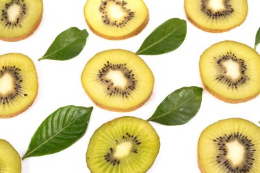An arrangement of fresh kiwi slices and green leaves on a white background.