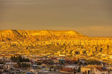 Kızıl Vadi ve Gül Vadisi ve Goreme şehir merkezi Kapadokya, Türkiye 'de günbatımının altında. Kızıl Vadi ve Gül Vadisi Kapadokyası isimlerini pembemsi kırmızı kayadan alır.  