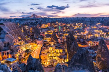 Goreme ilçesinin ulusal park Goreme, Kapadokya, Türkiye 'de kaya oluşumunda inşa edilen mağara oteli gece görüşü. 