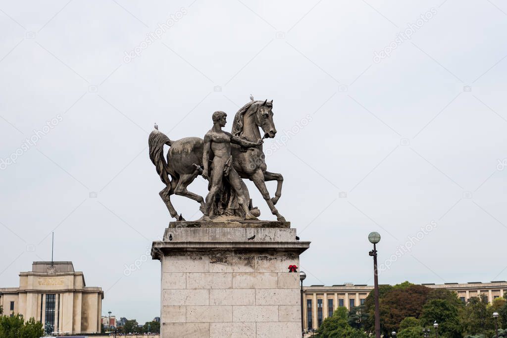  Statue Of Man And Horse on at the bridge pier on the bank of Seine river, in the downtown of Paris, France.