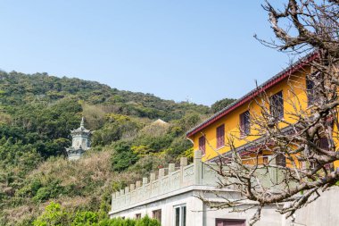Building of Chinese buddhist temple in Mount Luojia, which lies in the Lotus Sea to the southeast of Putuo Mountain, Zhoushan, Zhejiang, the place where Bodhisattva Guanyin practiced Buddhism clipart