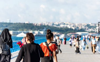 İstanbul, İstanbul, Türkiye 'deki Uskudar' daki Corniche parkında, İstanbul Boğazı 'nın Anadolu kıyılarında yürüyen insanlar.