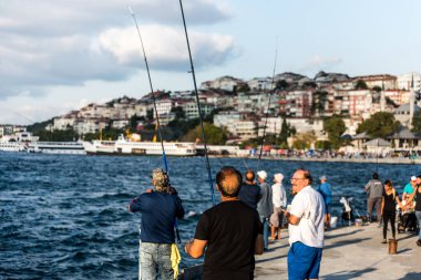 İstanbul, İstanbul, Türkiye 'deki Uskudar kentindeki Corniche parkında balıkçılık yapan insanlar, Boğazın Anadolu kıyısında.