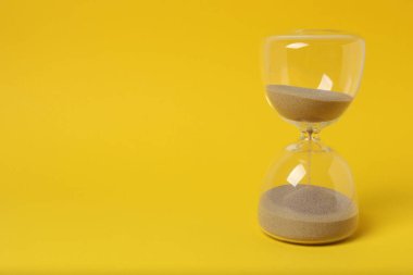 Sarı arka planda kum saati.