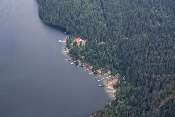 Aerial view of the remote homes by the water. Located on Indian Arm, North of Deep Cove, Vancouver, British Columbia, Canada.