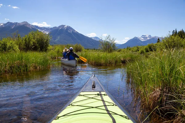 一对有冒险精神的朋友在一座被加拿大山脉包围的湖泊里划独木舟 在加拿大艾伯塔省班夫的朱红湖中拍摄 — 图库照片