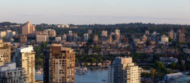 Aerial panoramic view of Residential Homes and Buildings around False Creek during a vibrant sunset. Taken in Downtown Vancouver, British Columbia, Canada. clipart