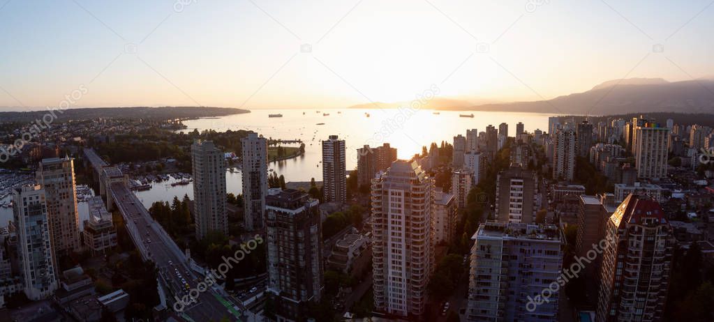 Beautiful aerial panoramic cityscape view during a vibrant sunny sunset. Taken in Downtown Vancouver, British Columbia, Canada.