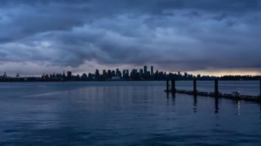 Şehir şehir zaman atlamalı dramatik bir bulutlu gün batımı sırasında. Lonsdale, North Vancouver, British Columbia, Kanada alınan.