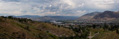 Aerial panoramic view of Kamloops City during a cloudy summer day. Located in Interior BC, Canada. clipart