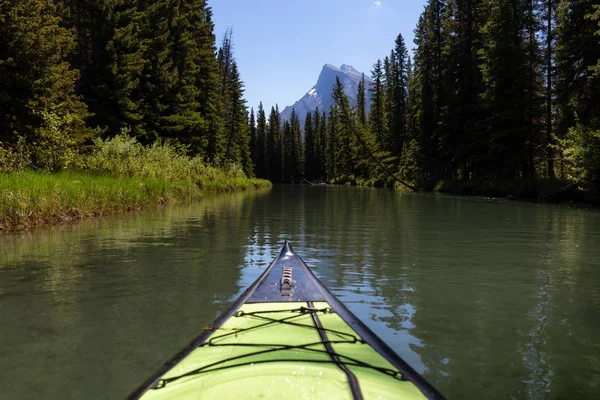 Kayaking in a river surrounded by the Canadian nature. Taken in Vermilion Lakes, Banff, Alberta, Canada.