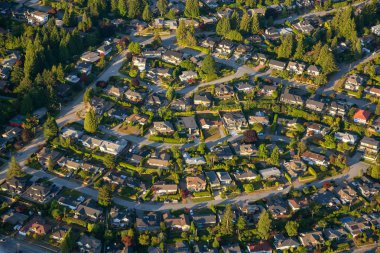 Aerial view of the residential homes during a vibrant sunny summer day. Taken in North Vancouver, British Columbia, Canada. clipart