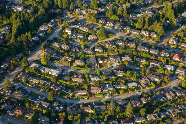 Aerial view of the residential homes during a vibrant sunny summer day. Taken in North Vancouver, British Columbia, Canada.