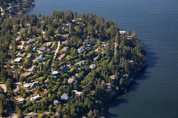 Aerial view of Residential homes by the ocean shore. Taken in Horseshoe Bay, West Vancouver, BC, Canada.