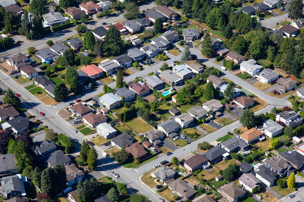 Aerial view of the residential homes in a suburban neighborhood. Taken in Burnaby, Greater Vancouver, BC, Canada.