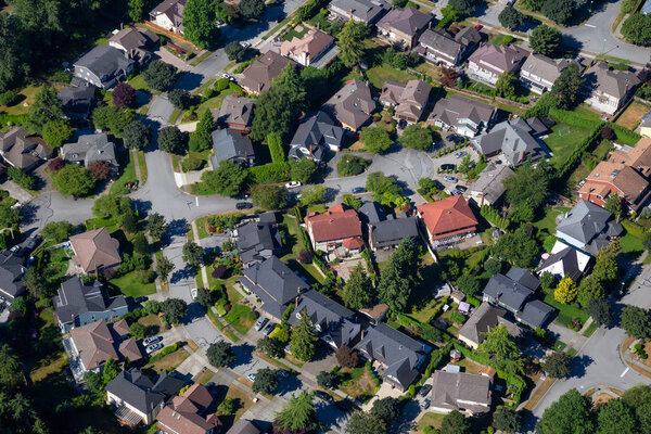 Aerial view of the residential homes in a suburban neighborhood. Taken in Burnaby, Greater Vancouver, BC, Canada.