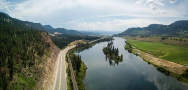 Aerial view of Trans-Canada Highway near Thompson River during a vibrant sunny summer day. Taken near Kamloops, BC, Canada. clipart