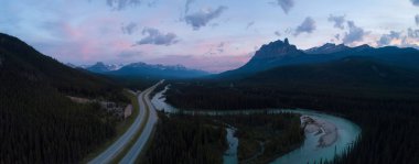 Beautiful aerial panoramic landscape view of a Trans-Canada Highway in Canadian Rockies during a vibrant sunny day. Taken in Banff, Alberta, Canada. clipart