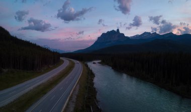 Beautiful aerial panoramic landscape view of a Trans-Canada Highway in Canadian Rockies during a vibrant sunny day. Taken in Banff, Alberta, Canada. clipart