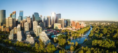 Aerial panoramic view of a beautiful modern cityscape during a vibrant sunny sunrise. Taken in Calgary Downtown, Alberta, Canada. clipart