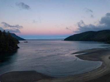 Striking aerial view of the Pacific Ocean Coast during a vibrant summer sunrise. Taken in San Josef Bay, Cape Scott, Northern Vancouver Island, BC, Canada. clipart