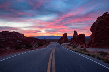 Scenic view on the road in the desert during a dramatic sunrise. Taken in Valley of Fire State Park, Nevada, United States. clipart