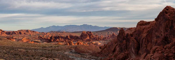 Beautiful panoramic American Landscape during a cloudy sunrise. Taken in Valley of Fire State Park, Nevada, United States.