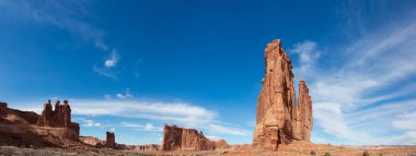 Landscape view of beautiful red rock canyon formations during a vibrant sunny day. Taken in Arches National Park, located near Moab, Utah, United States. clipart