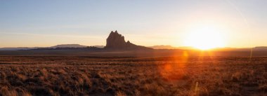 Panoramik manzaralı bir kuru çöl dağ tepe ile canlı bir gün batımı sırasında arka planda dikkat çekici. Shiprock, New Mexico, Amerika Birleşik Devletleri, alınan.