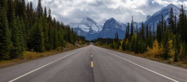 Beautiful panoramic view of a scenic road in the Canadian Rockies during Fall Season. Taken in Icefields Pkwy, Jasper, Alberta, Canada. clipart