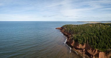 Aerial panoramic view of a beautiful rocky shore on the Atlantic Ocean. Taken in Cabot Beach Provincial Park, Prince Edward Island, Canada. clipart