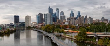 Philadelphia, Pennsylvania, United States - October 28, 2018: Panoramic view of a modern Downtown City during a cloudy day. clipart