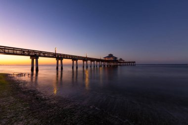 Ahşap bir iskele güzel manzarasına canlı gün doğumu sırasında Atlantik Okyanusu üzerinde. Fort Myers Beach, Florida, Amerika Birleşik Devletleri'nde çekilen.