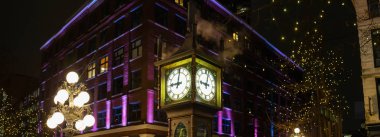 Panoramic View of Steam Clock during a dark winter night in Gastown, Downtown Vancouver, BC, Canada. clipart