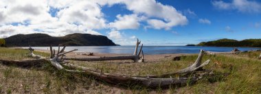 Beautiful view of a sandy beach during a sunny day. Taken in Old Woman Bay, Lake Superior Provincial Park, Ontario, Canada. clipart
