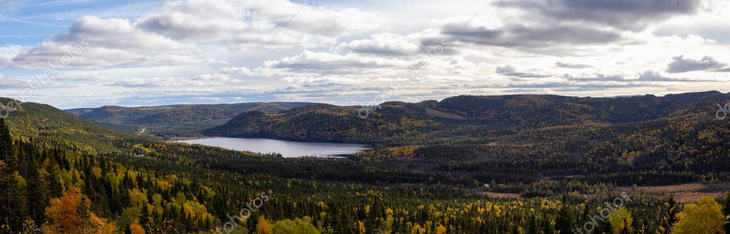 Panoramic view of a beautiful Canadian Landscape during a vibant sunny day in Fall Season. Taken in Gros Morne National Park, Newfoundland, Canada.