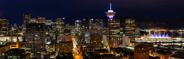 Beautiful panoramic view of the modern cityscape from an aerial perspective at night. Taken in Downtown Vancouver, BC, Canada.